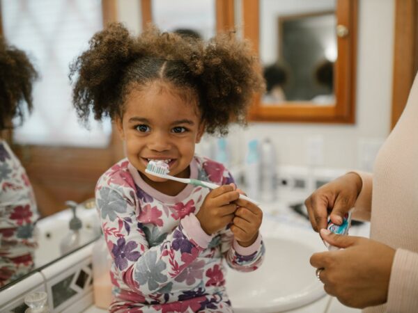 Curly Haired Girl Brushing Teeth