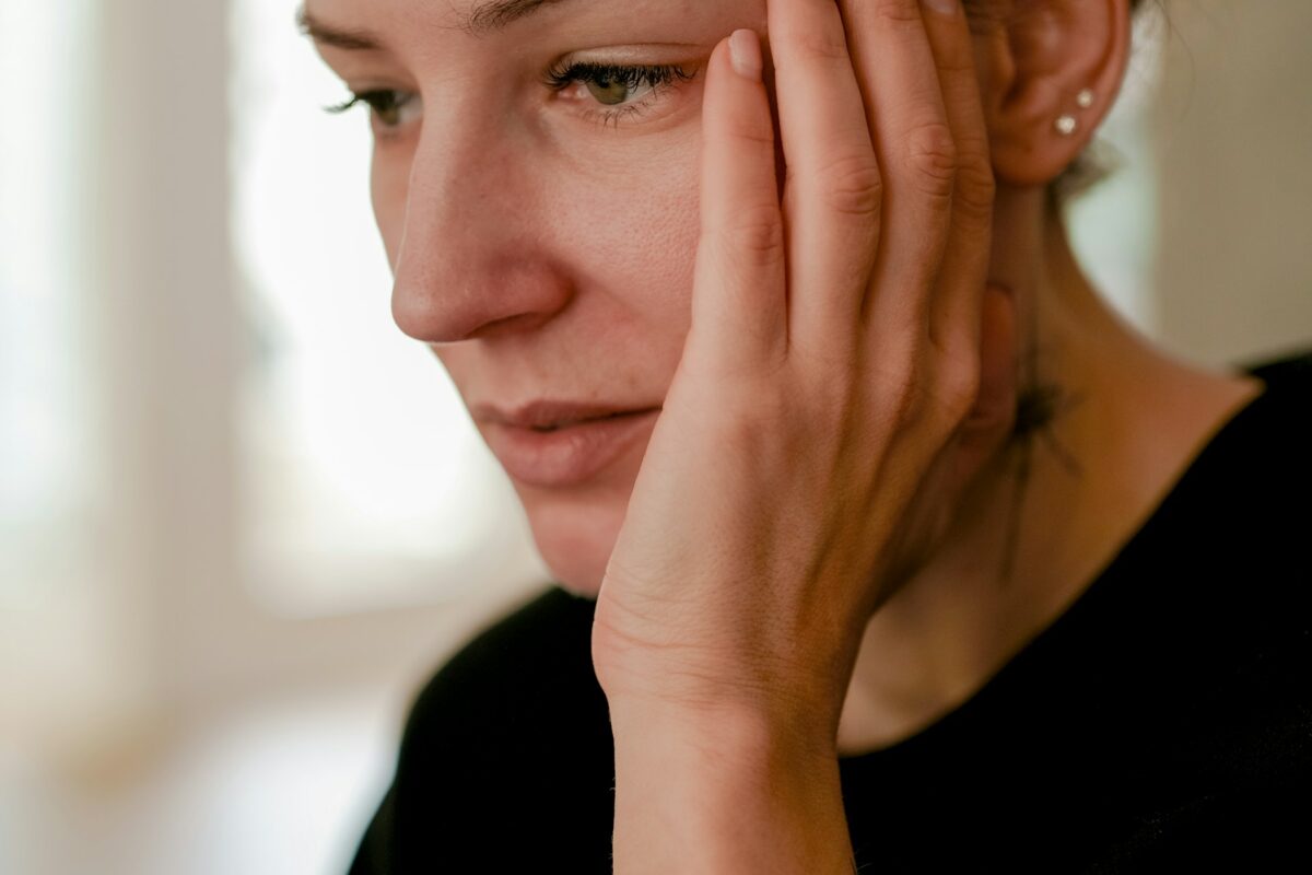 woman holding face