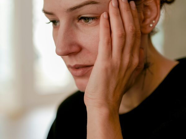 woman holding face